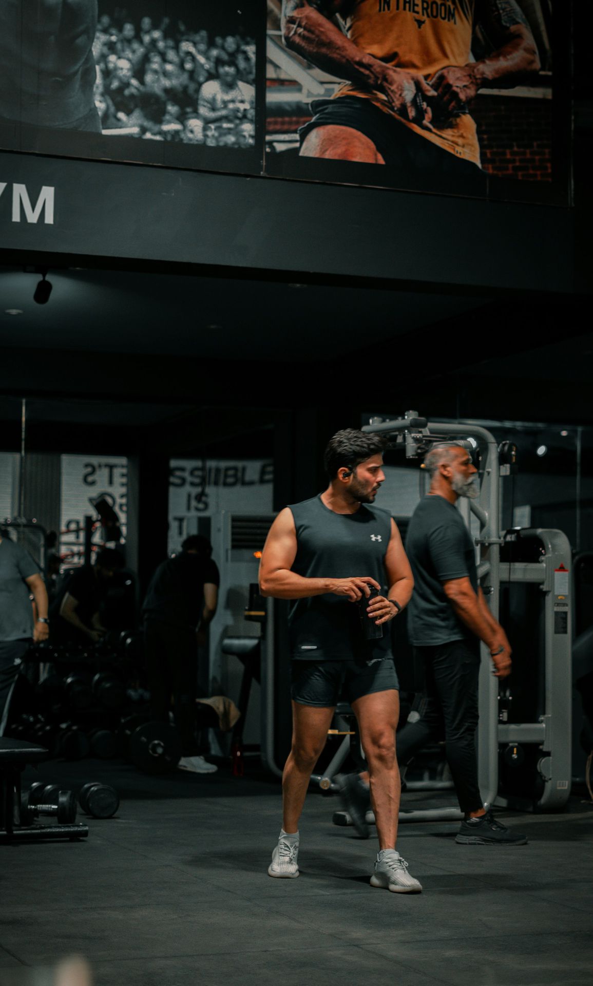 Man stands in gym after his workout.
